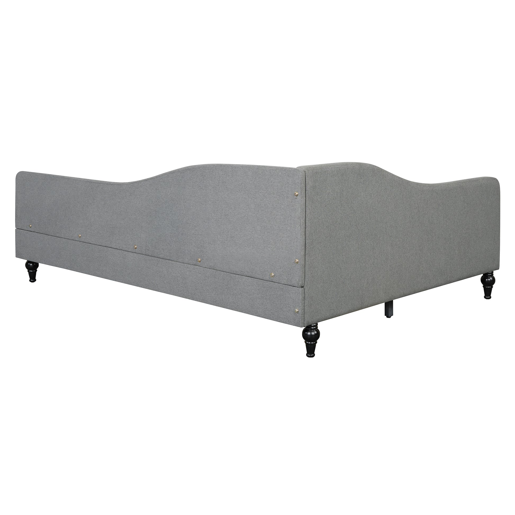 Gray upholstered daybed with curved back and ornate black legs