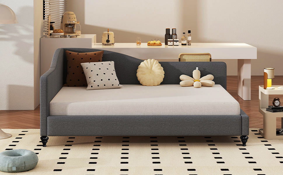 Dark grey upholstered daybed with patterned pillows