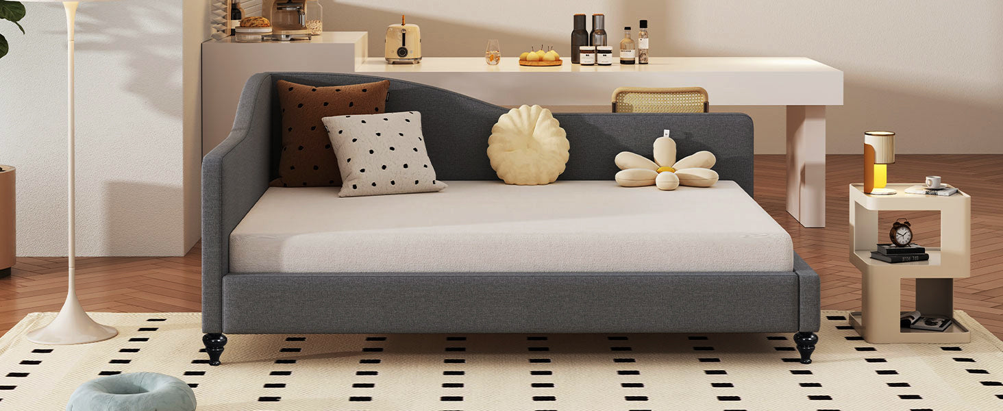 Grey upholstered daybed with decorative pillows
