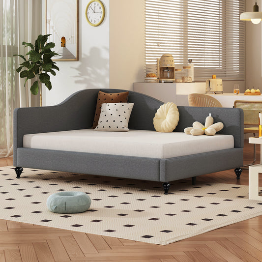 Gray upholstered daybed with curved arms and black legs