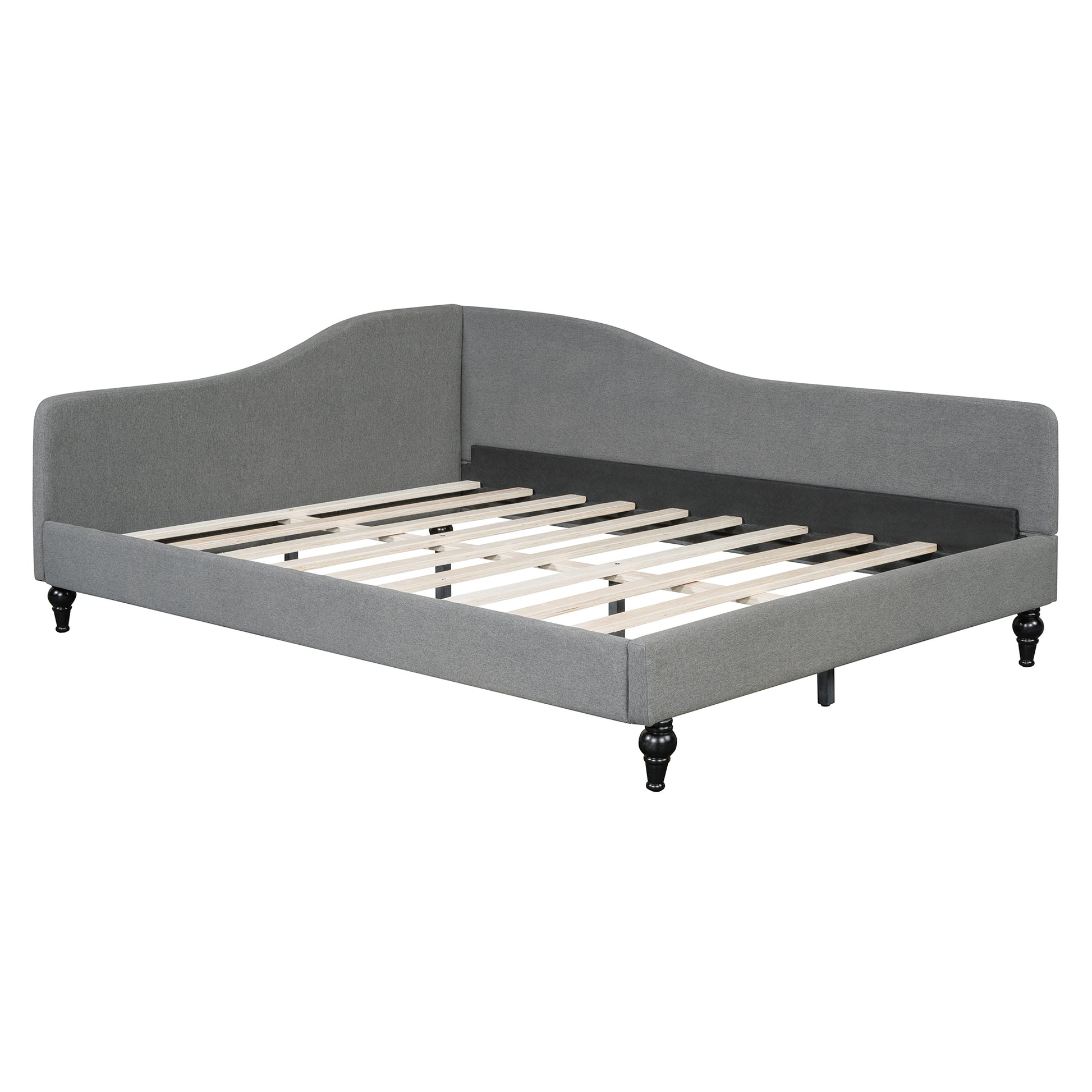 Grey upholstered daybed with ornate legs and wooden slat support
