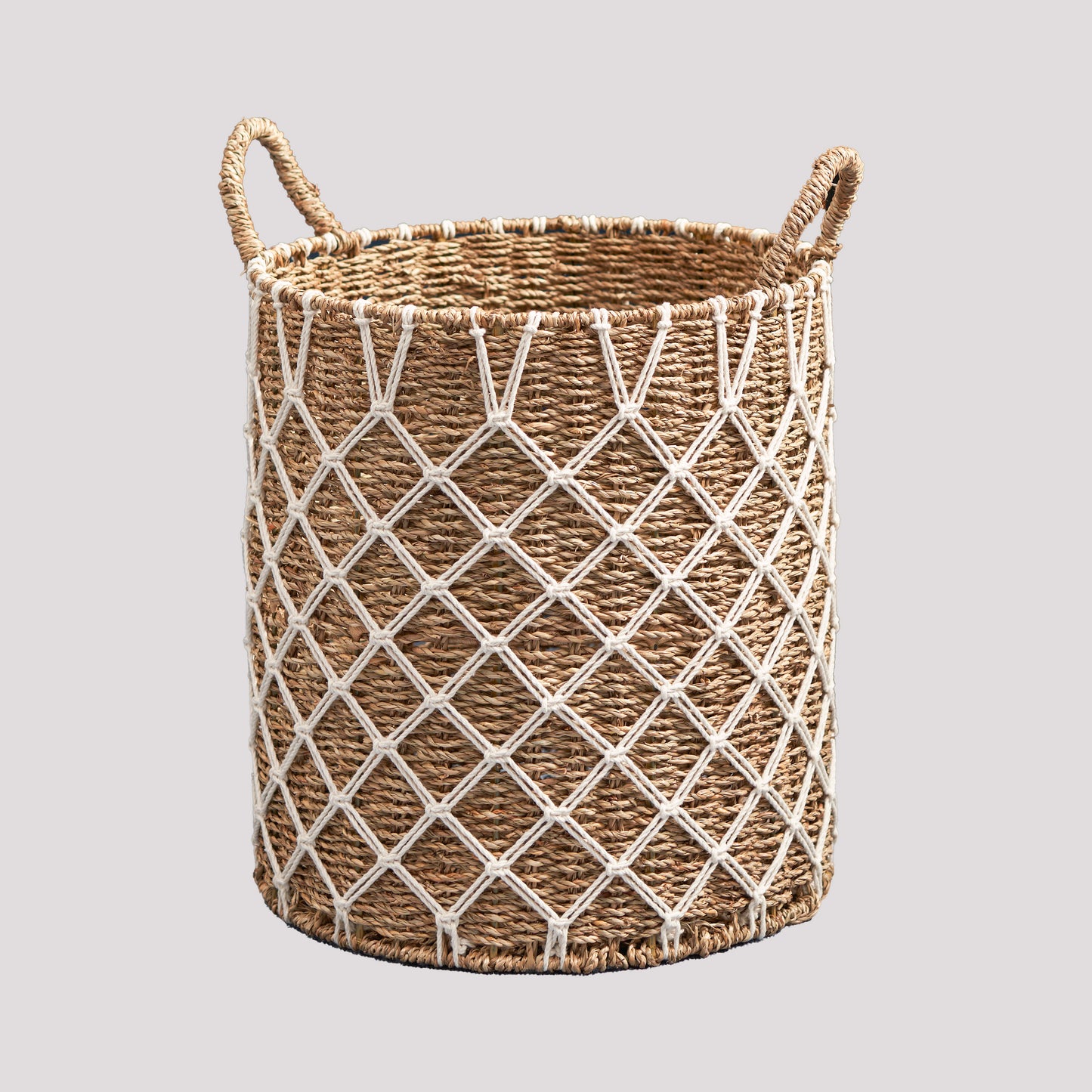 Handwoven seagrass laundry basket with macrame detailing and handles