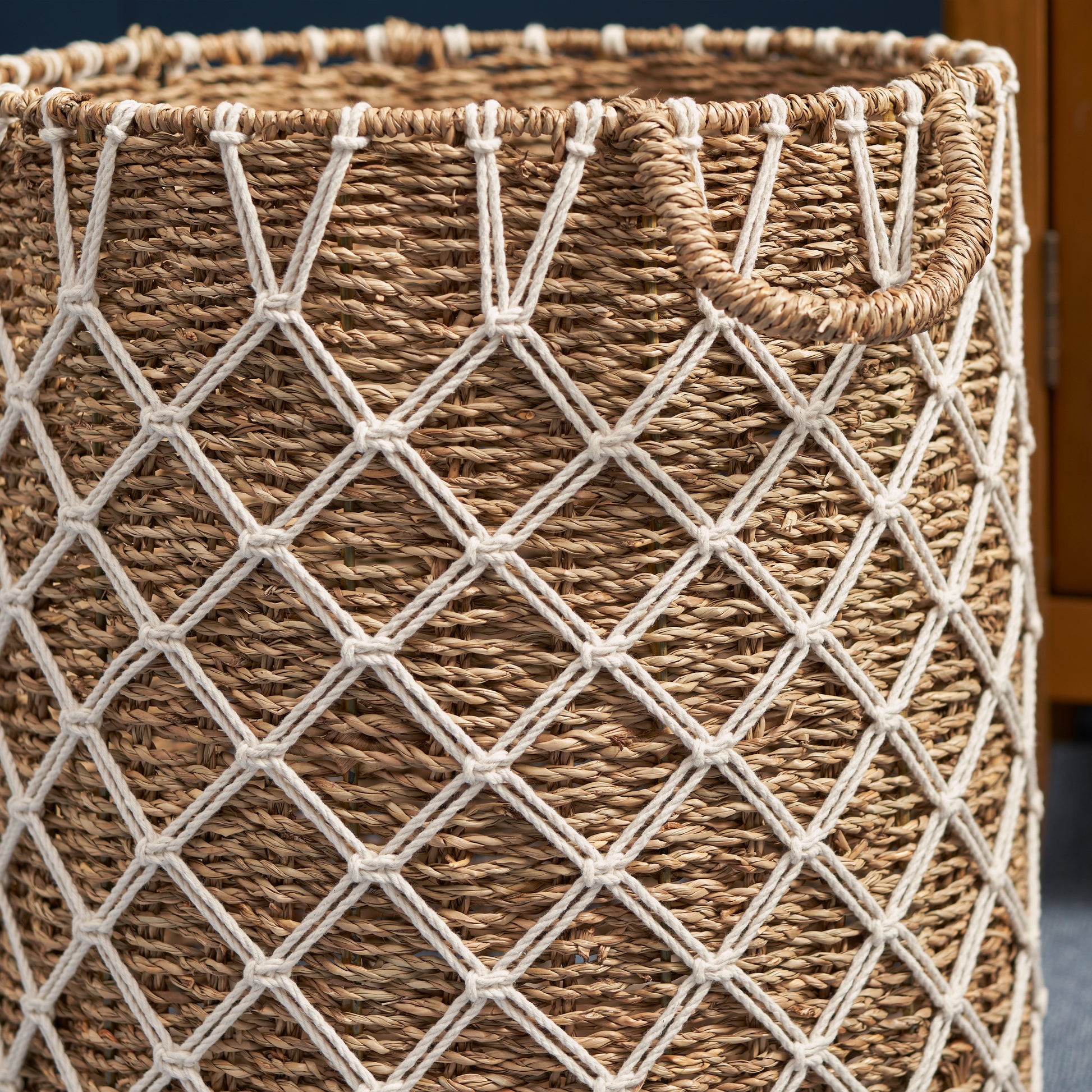 Woven seagrass storage basket with macrame detail and handles