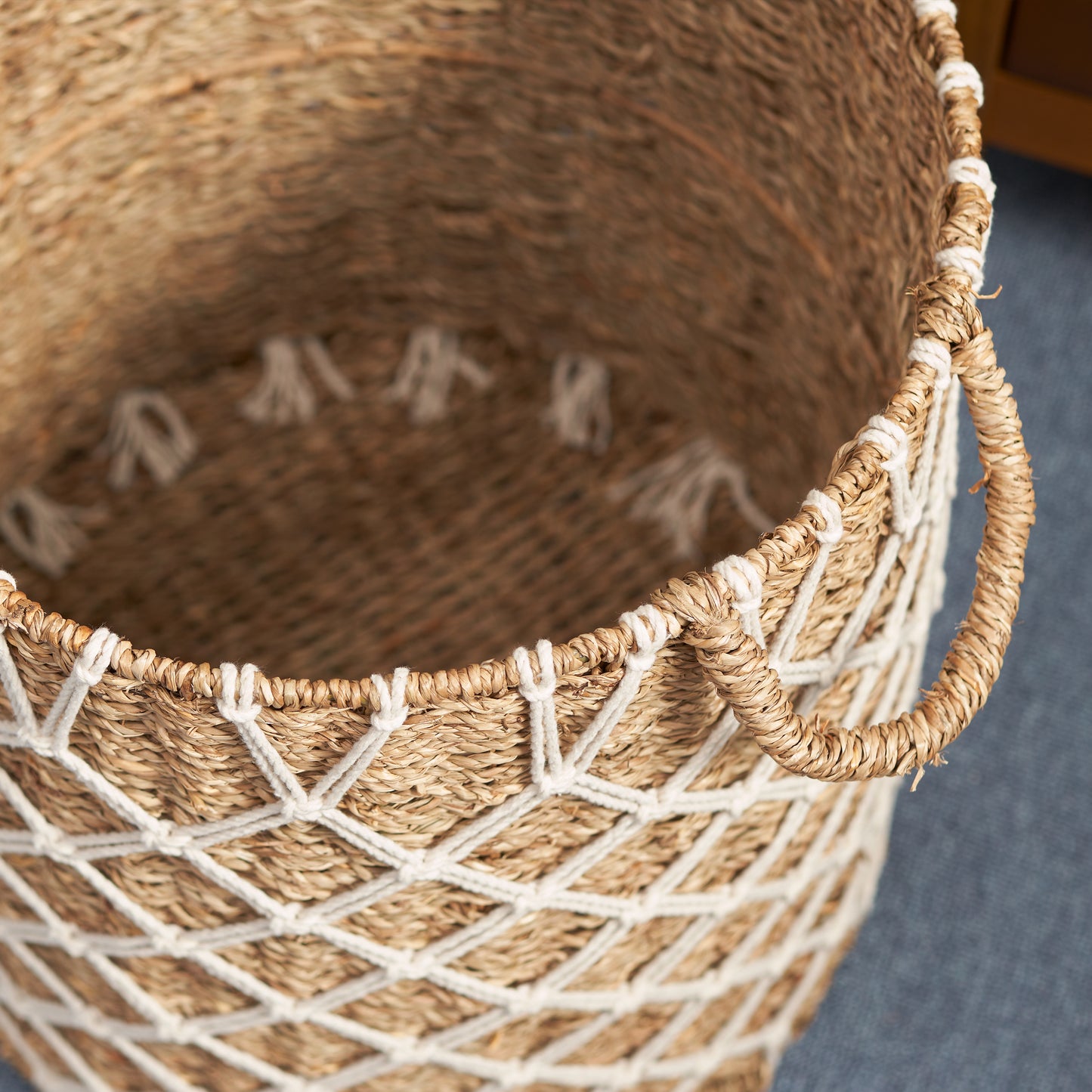 Woven seagrass storage basket with white rope accents