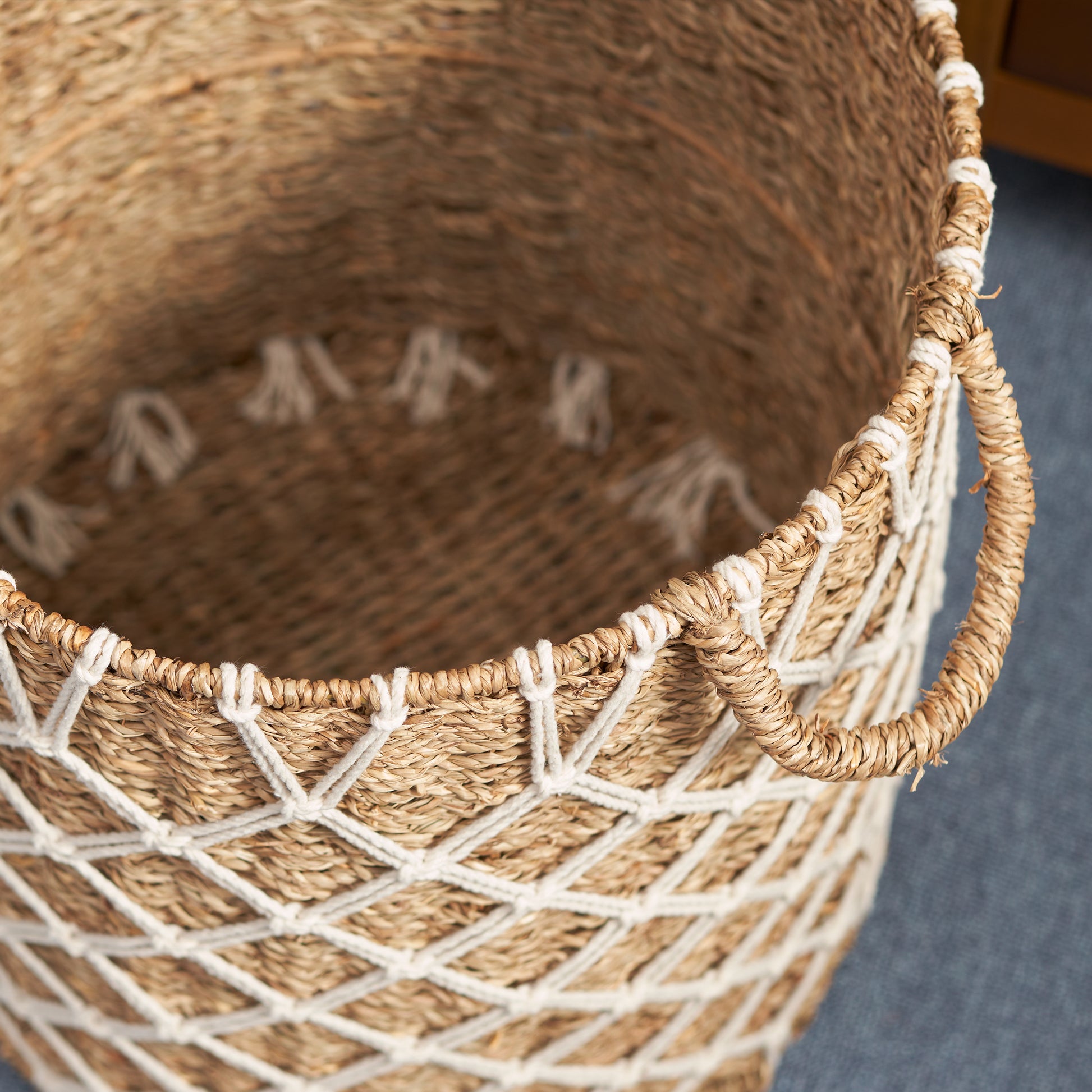 Woven seagrass storage basket with white rope accents
