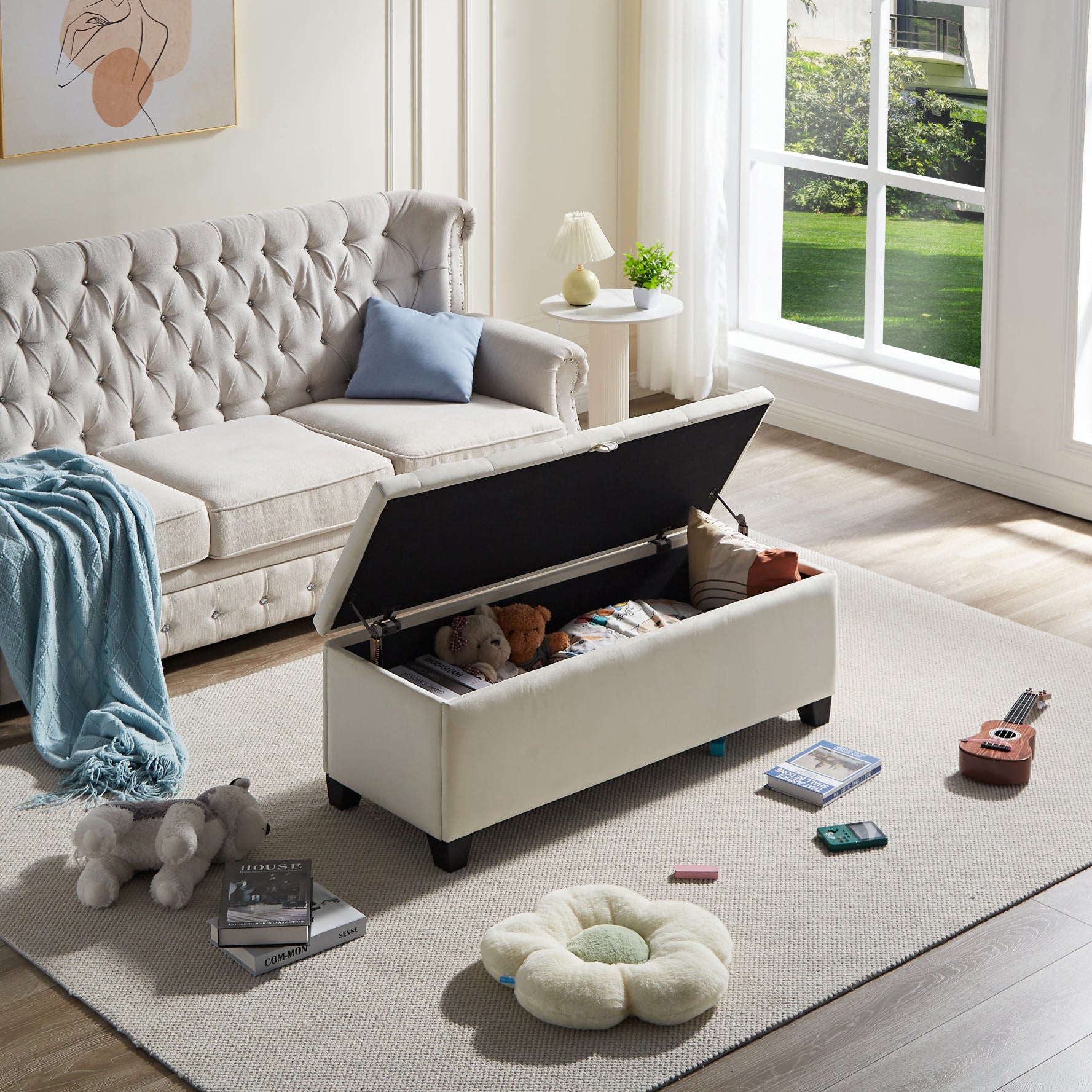 Cream velvet storage ottoman with tufted lid and black legs