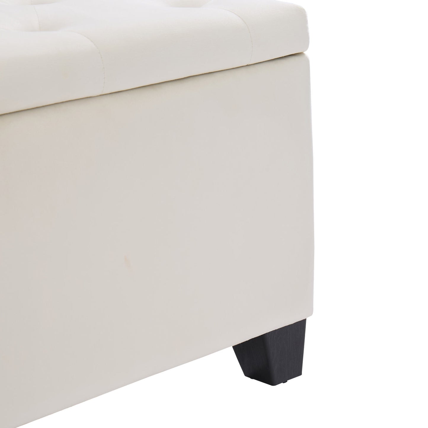 Cream upholstered storage ottoman with button tufted lid and dark wood feet