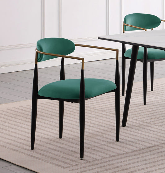 Emerald green velvet dining chair with gold arms and black tapered legs
