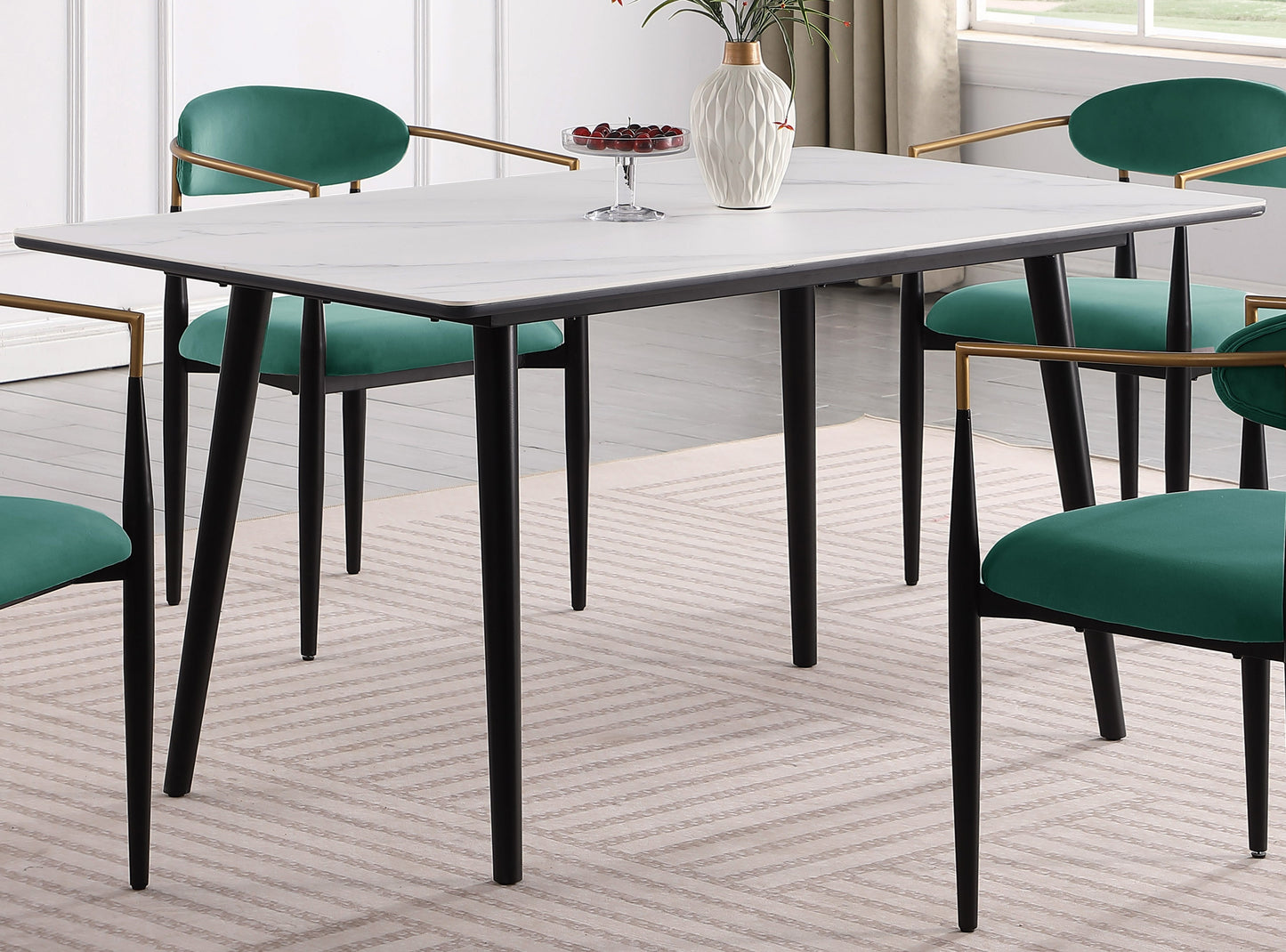 Rectangular marble dining table with black legs and emerald green chairs