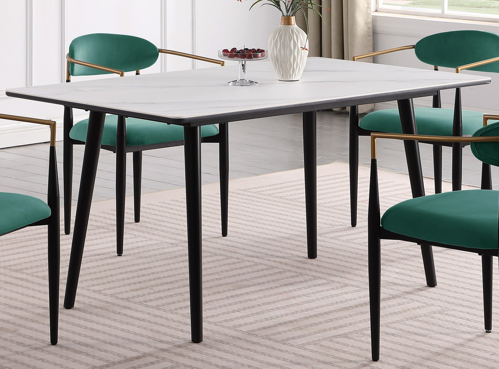 Rectangular marble dining table with black legs and emerald green chairs