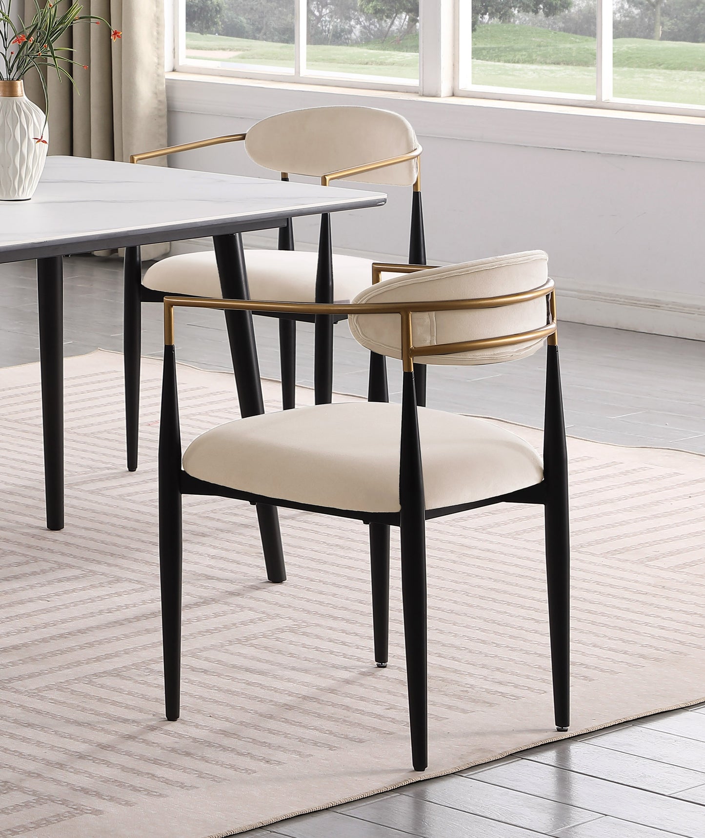 Modern cream upholstered dining chair with gold accent frame and black legs