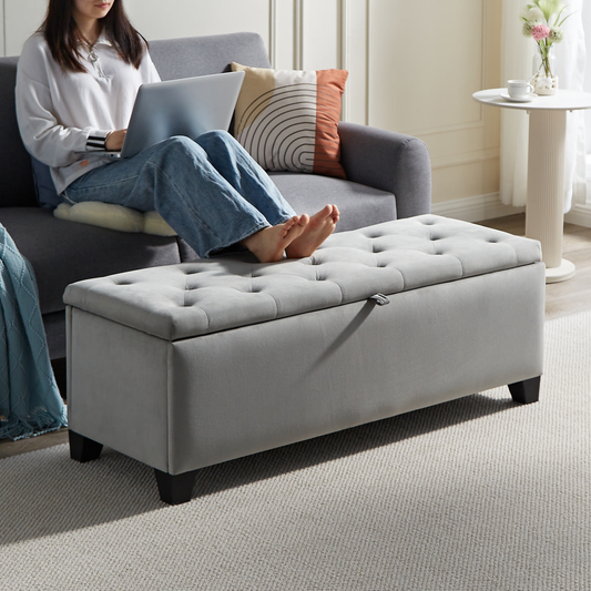 Gray velvet storage ottoman with tufted lid and silver handle