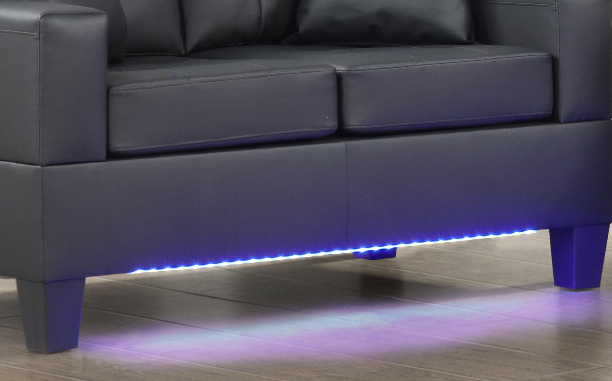 Black leather sofa with ambient LED lighting accentuating the base