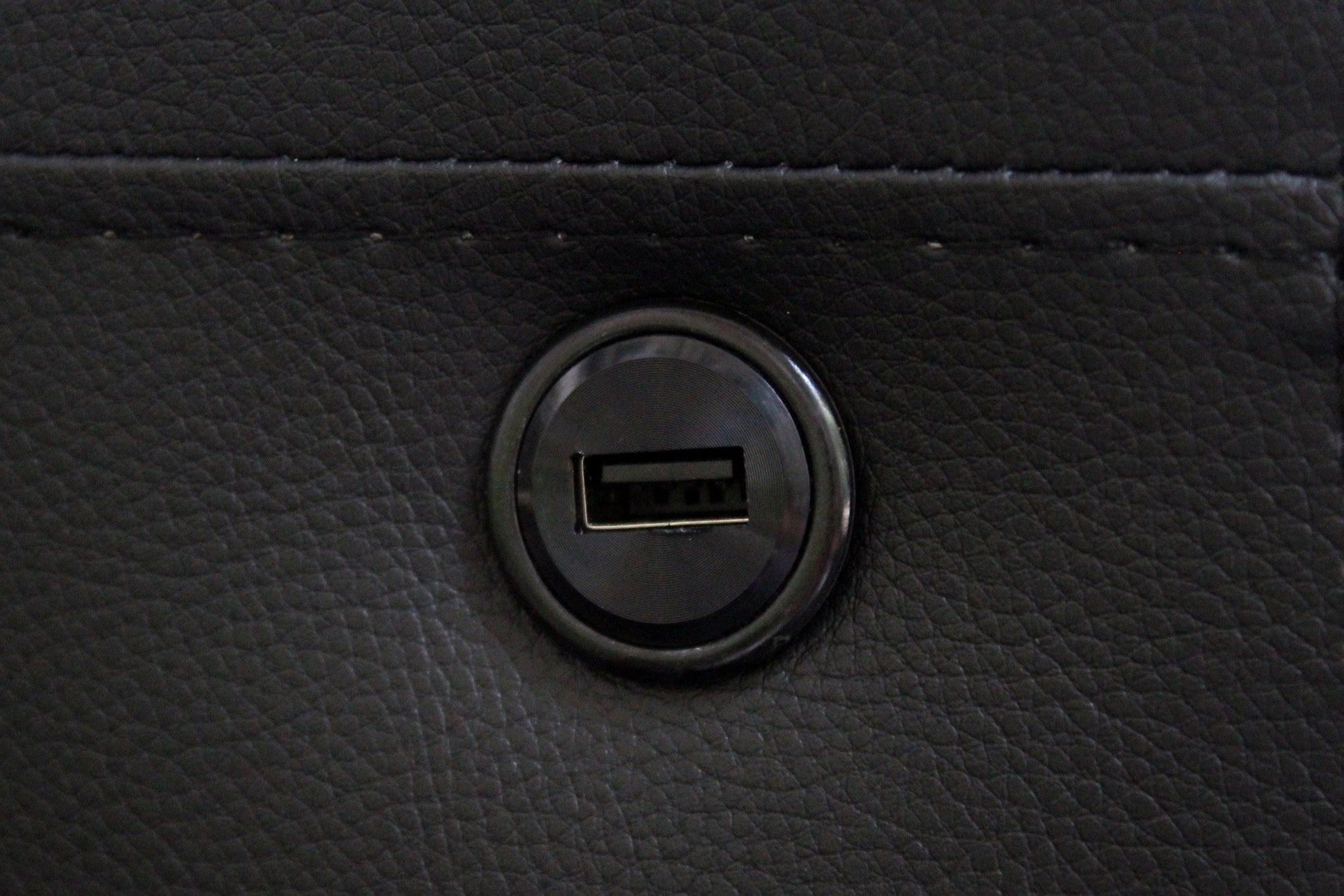 Black faux leather recliner with builtin USB charging port for modern convenience