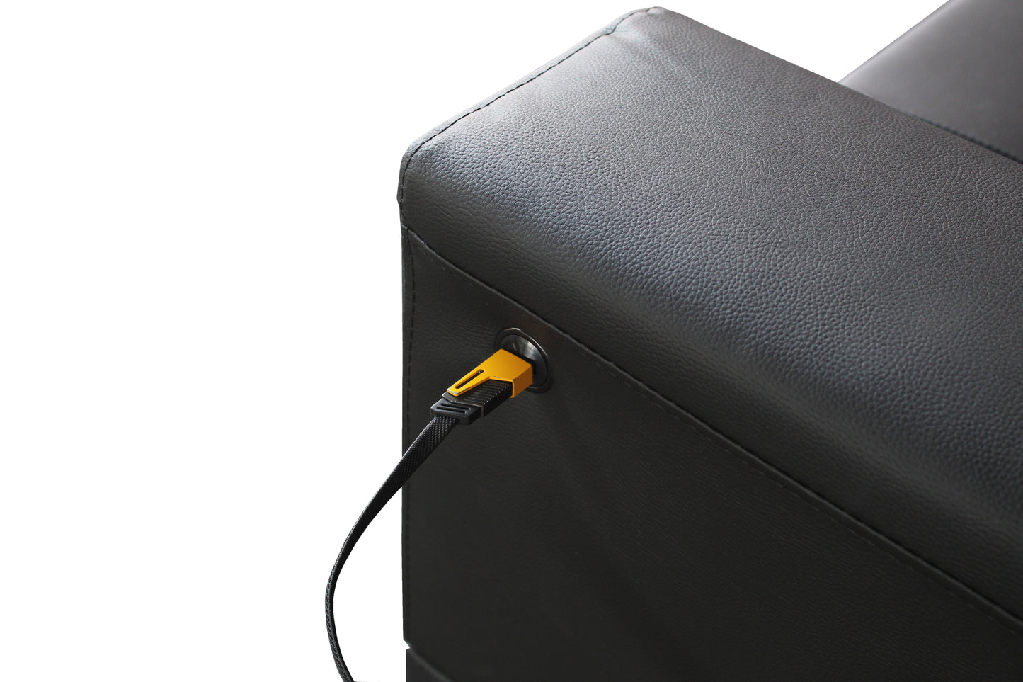 Black faux leather armchair armrest with integrated charging port and yellow connector