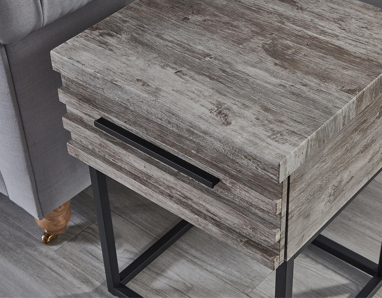 Gray wood grain end table with black metal legs and drawer