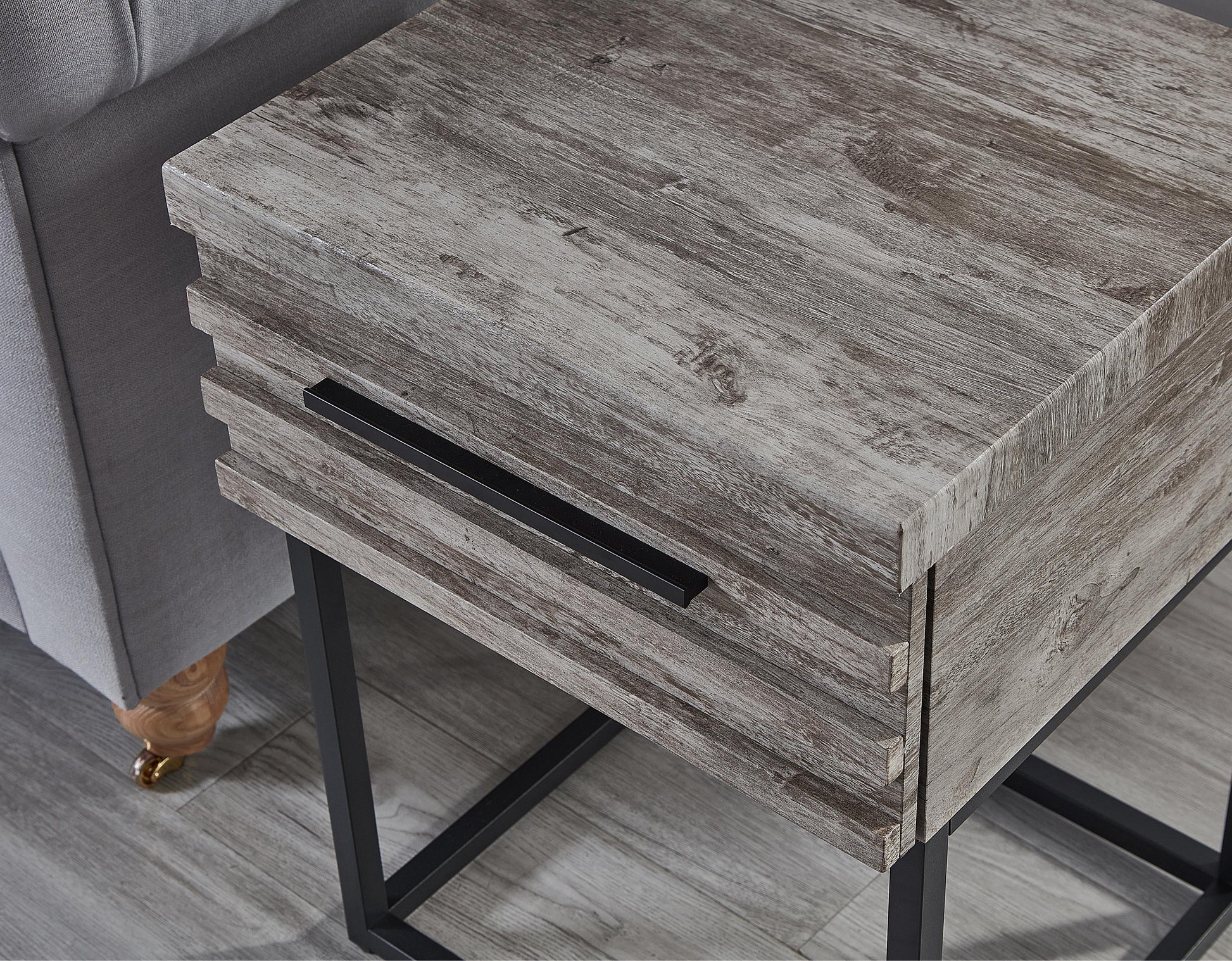 Gray wood grain end table with black metal legs and drawer