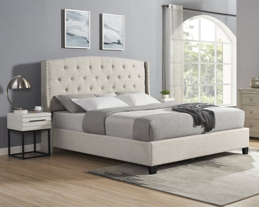 Tufted beige fabric king bed with studded headboard and matching linens