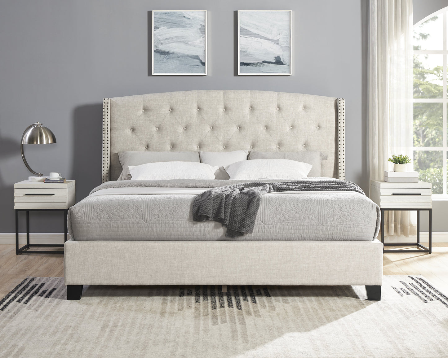 Tufted beige upholstered bed with nailhead trim