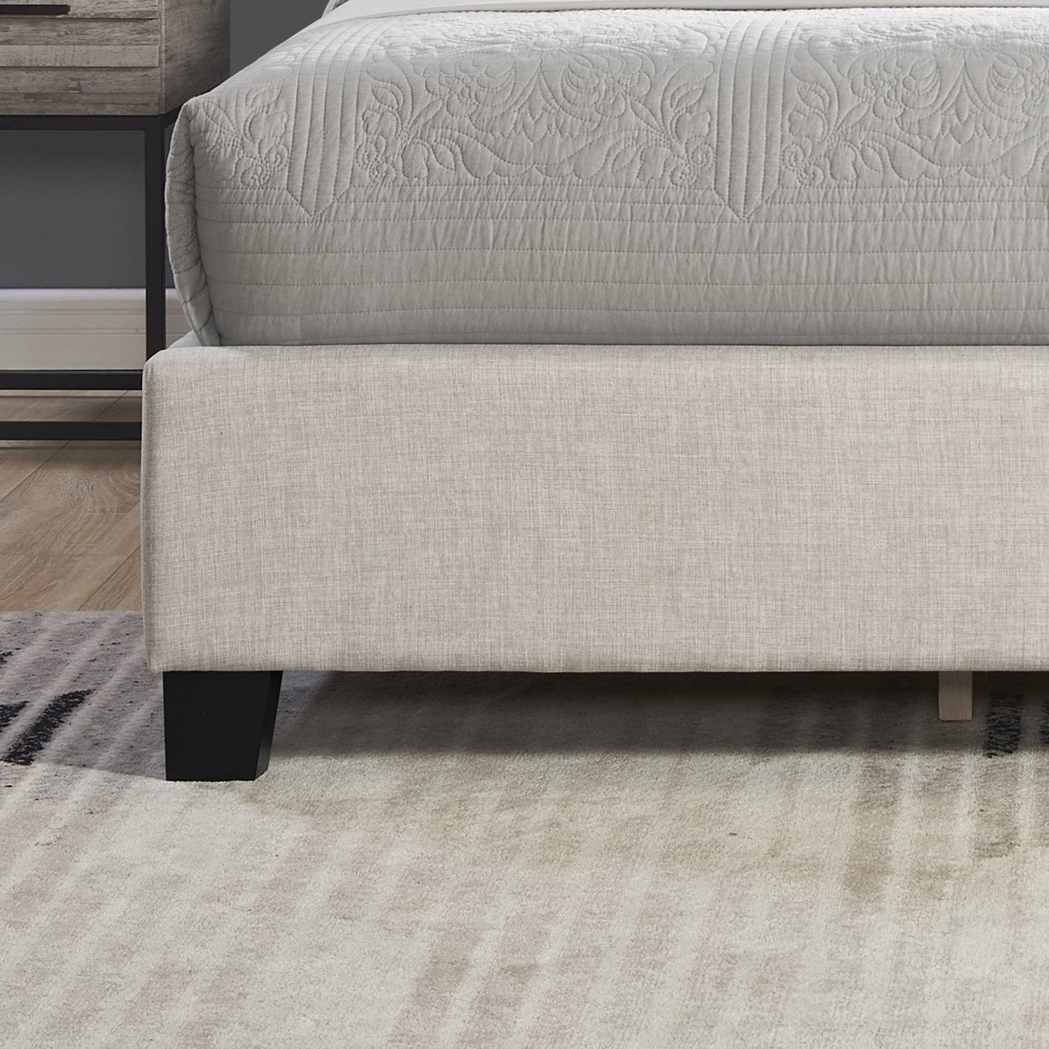 Beige upholstered bed frame with minimalist black legs