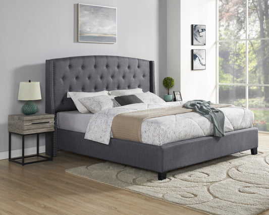 Dark grey fabric tufted king size bed with nailhead trim and plush bedding