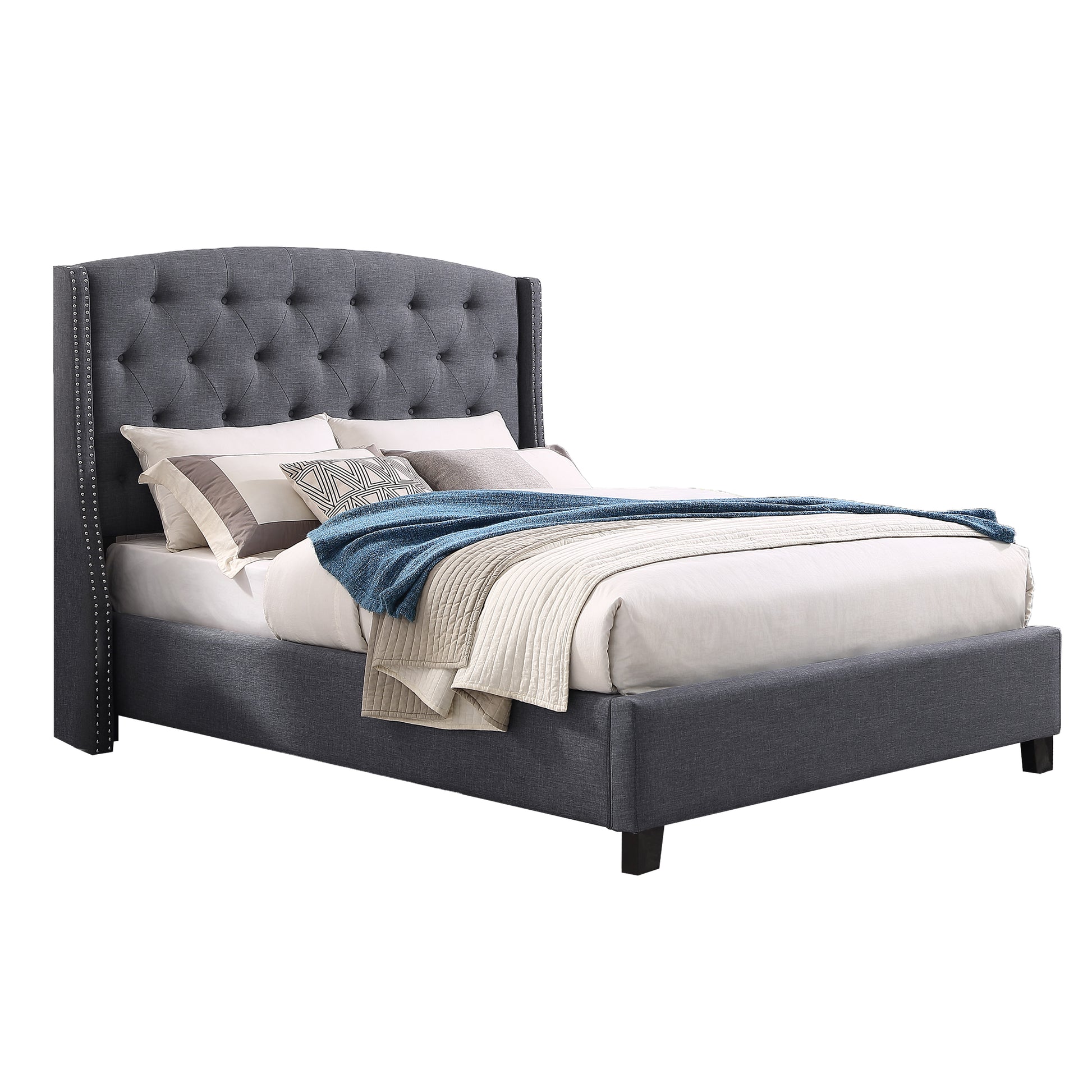 Dark gray upholstered wingback bed with tufted headboard and silver nailhead trim