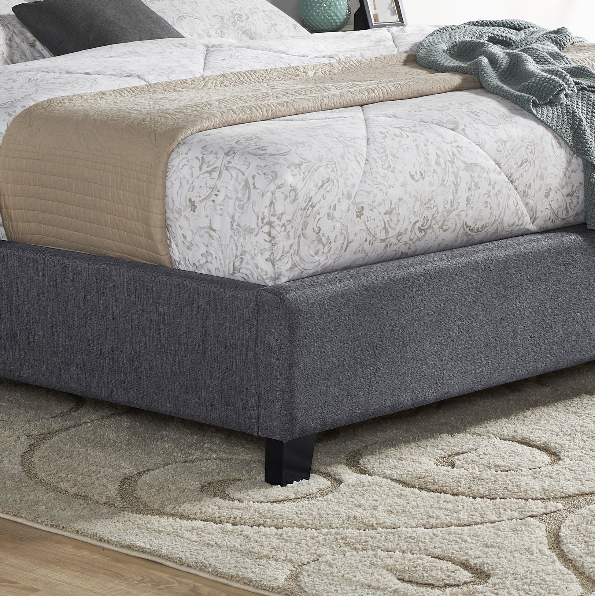 Charcoal upholstered bed frame with a textured weave showcasing minimalist design for modern bedrooms