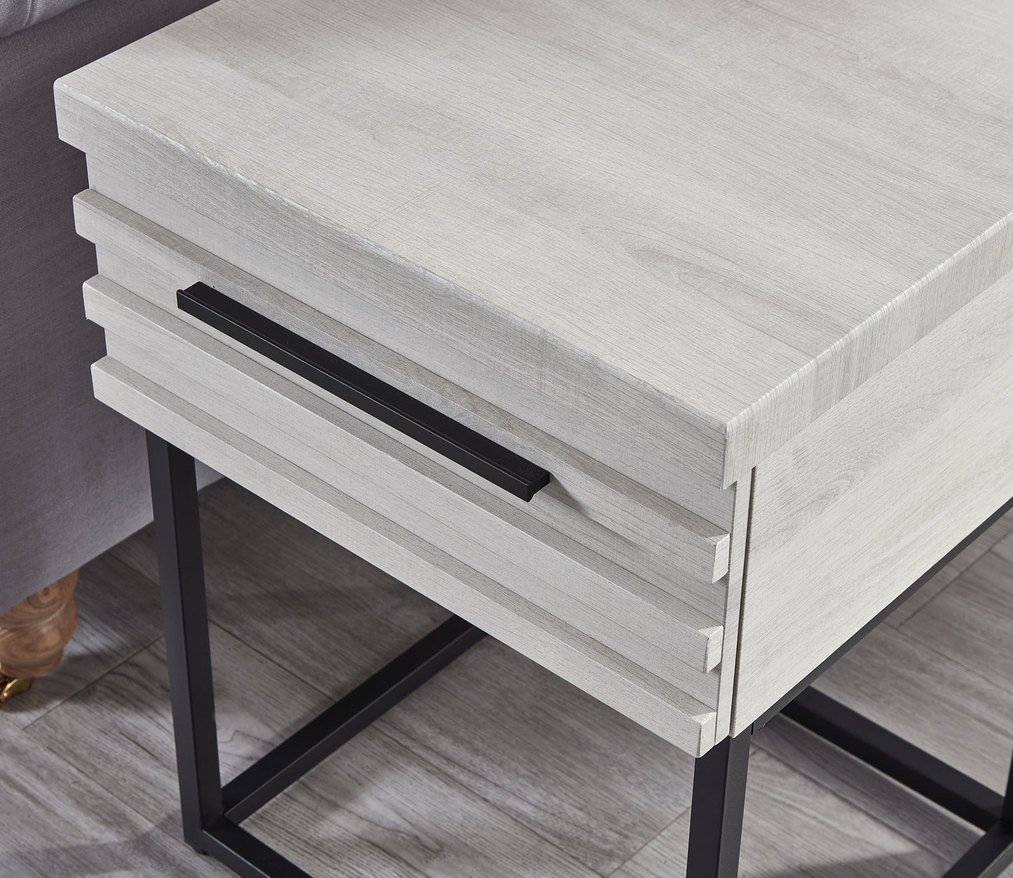 Weathered white wood end table with black metal legs and drawer pull