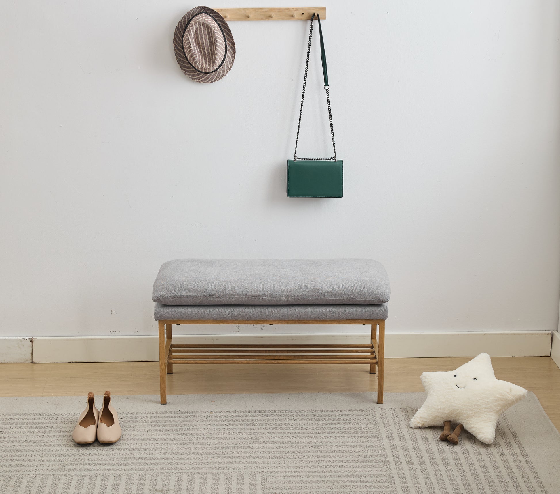 Gray upholstered bench with wooden frame and shoe rack