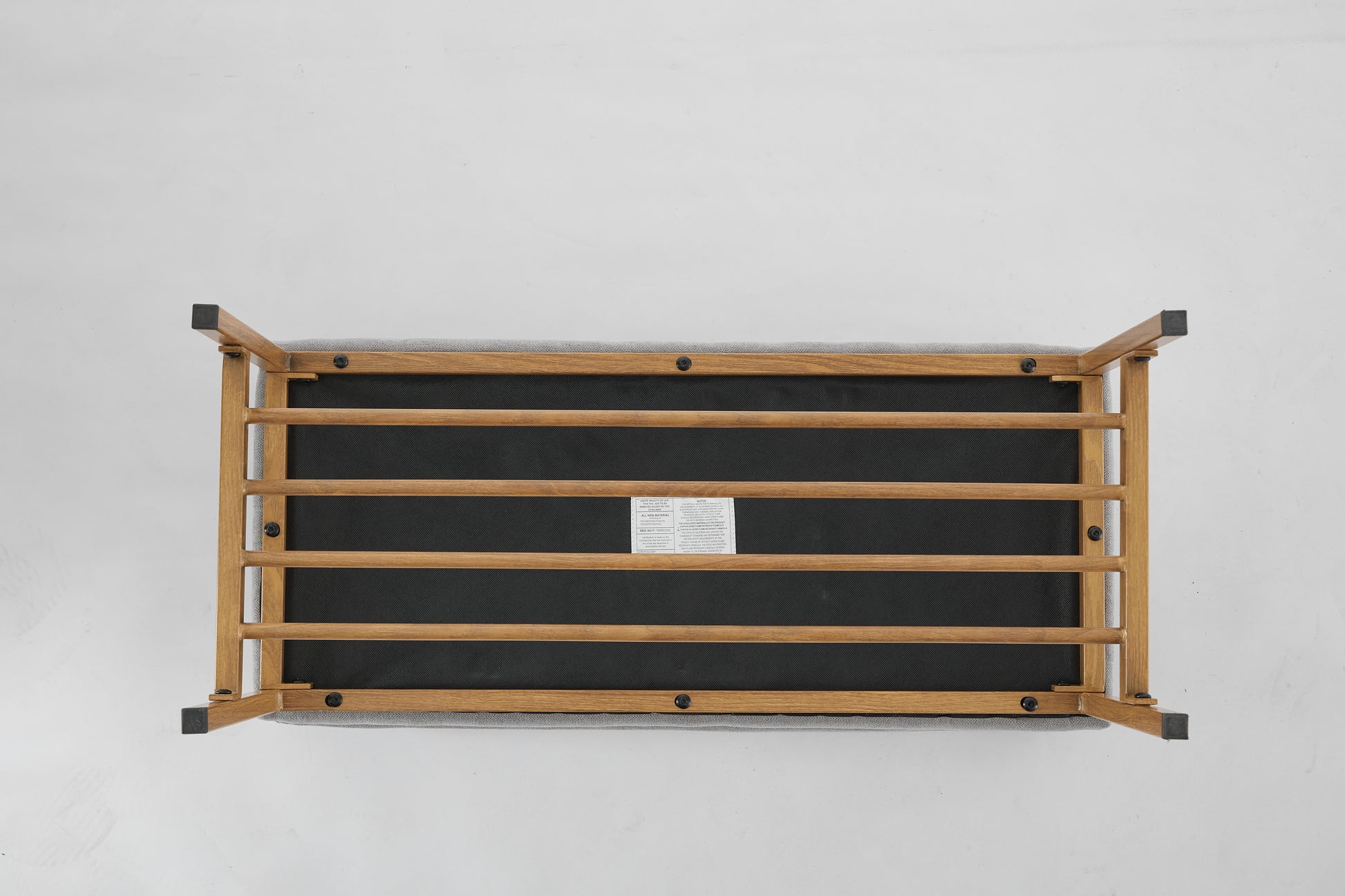 Wooden bench base with grey fabric upholstery and black protective feet