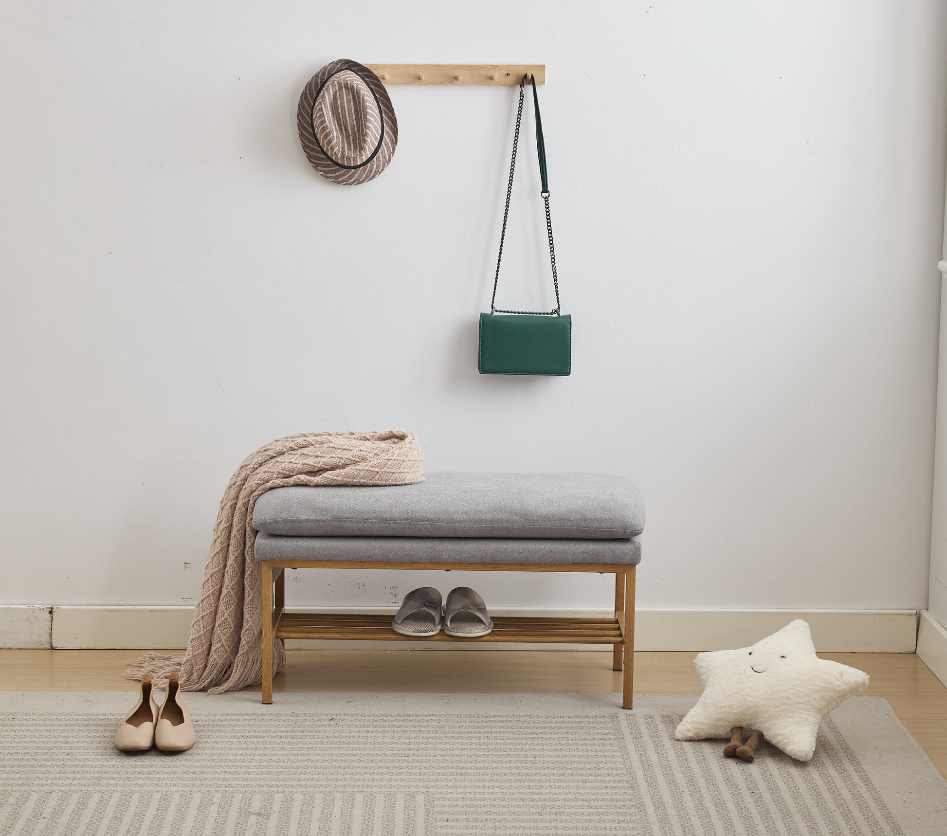 Grey upholstered entryway bench with wooden legs and shelf