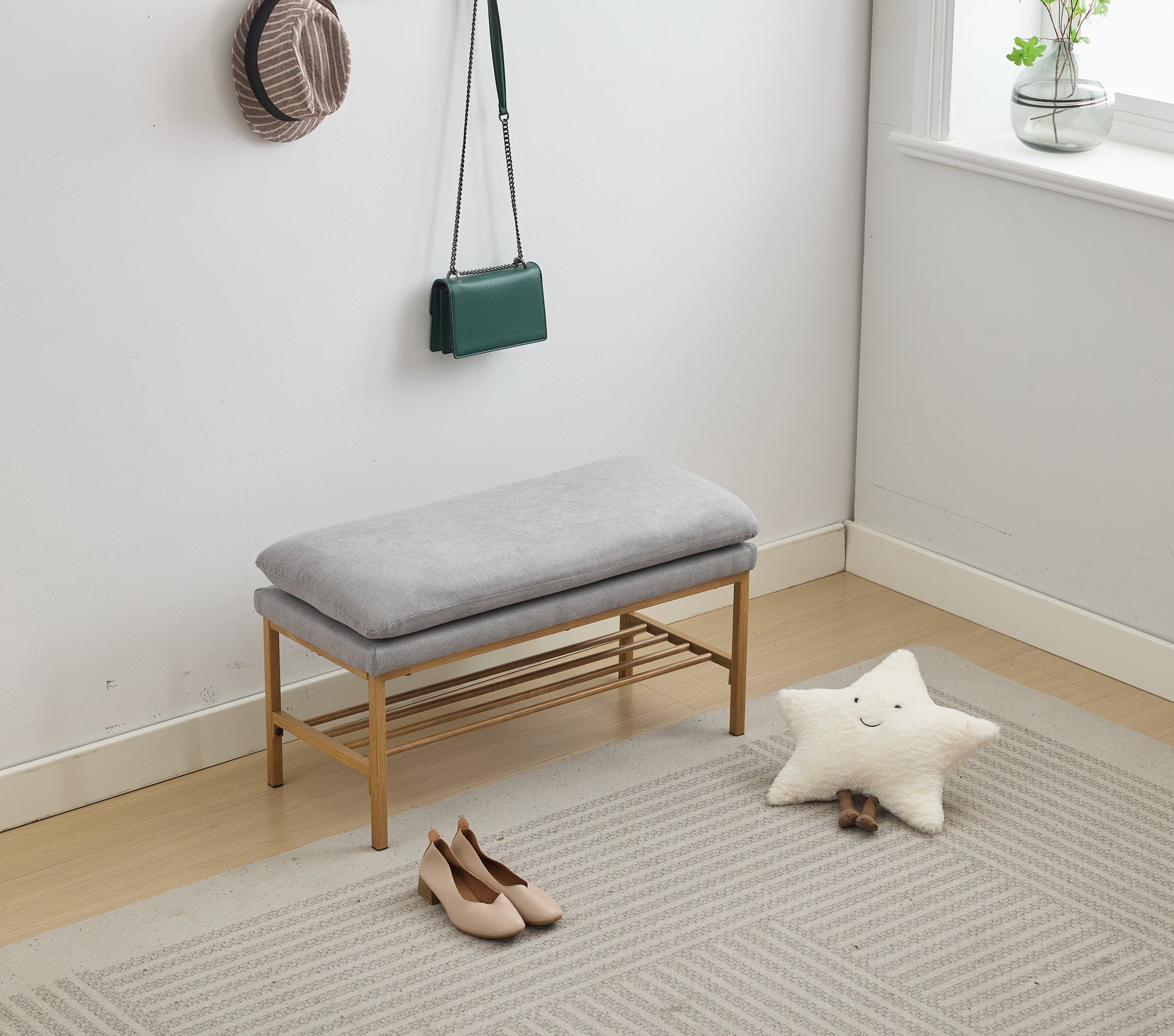 Grey fabric entryway bench with gold frame and shoe rack