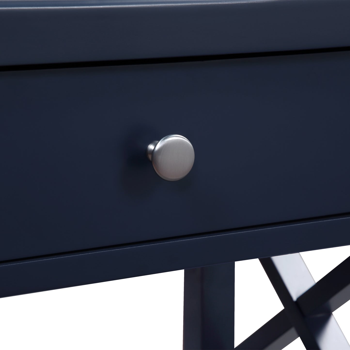 Closeup of a dark blue wooden desk with a brushed nickel knob