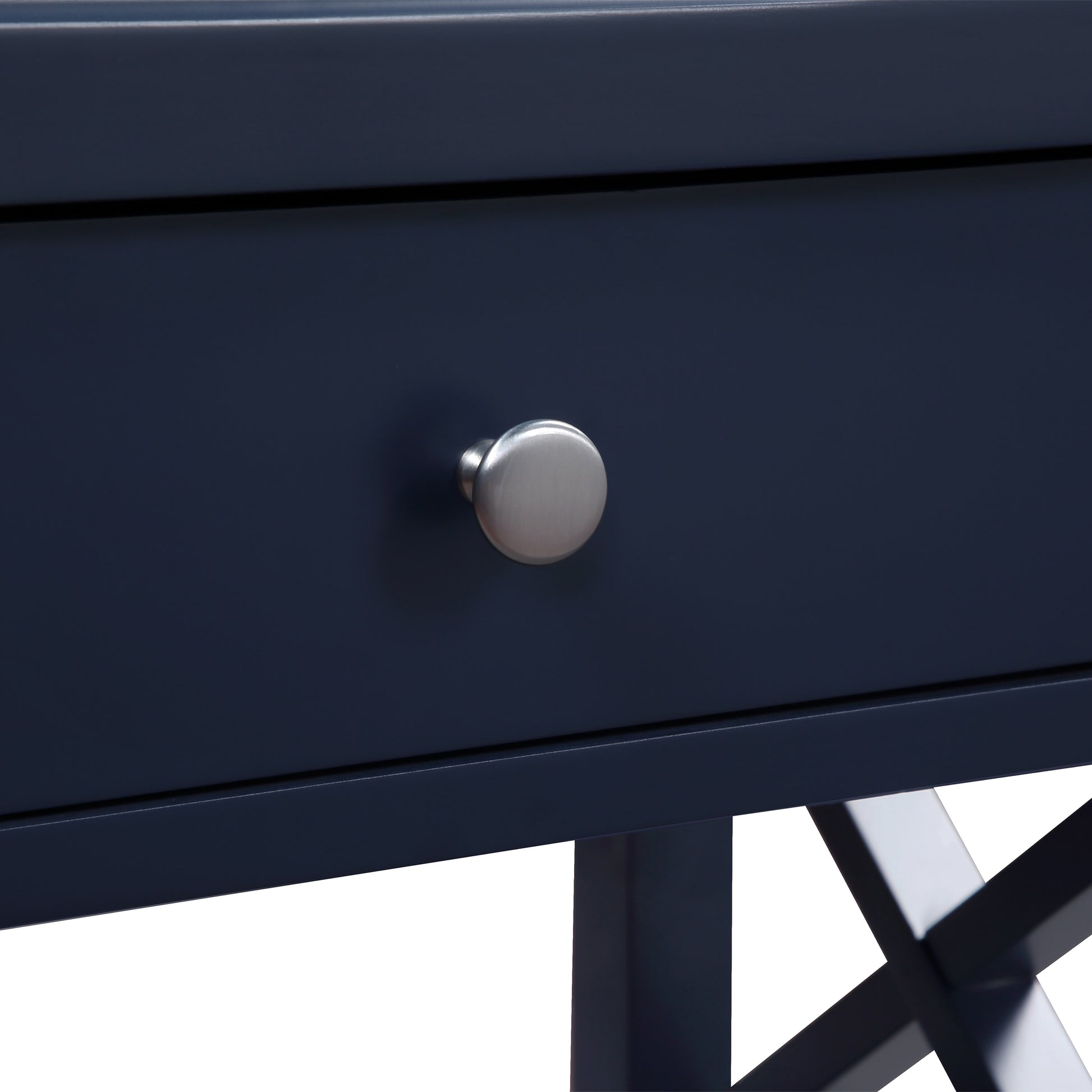 Closeup of a dark blue wooden desk with a brushed nickel knob