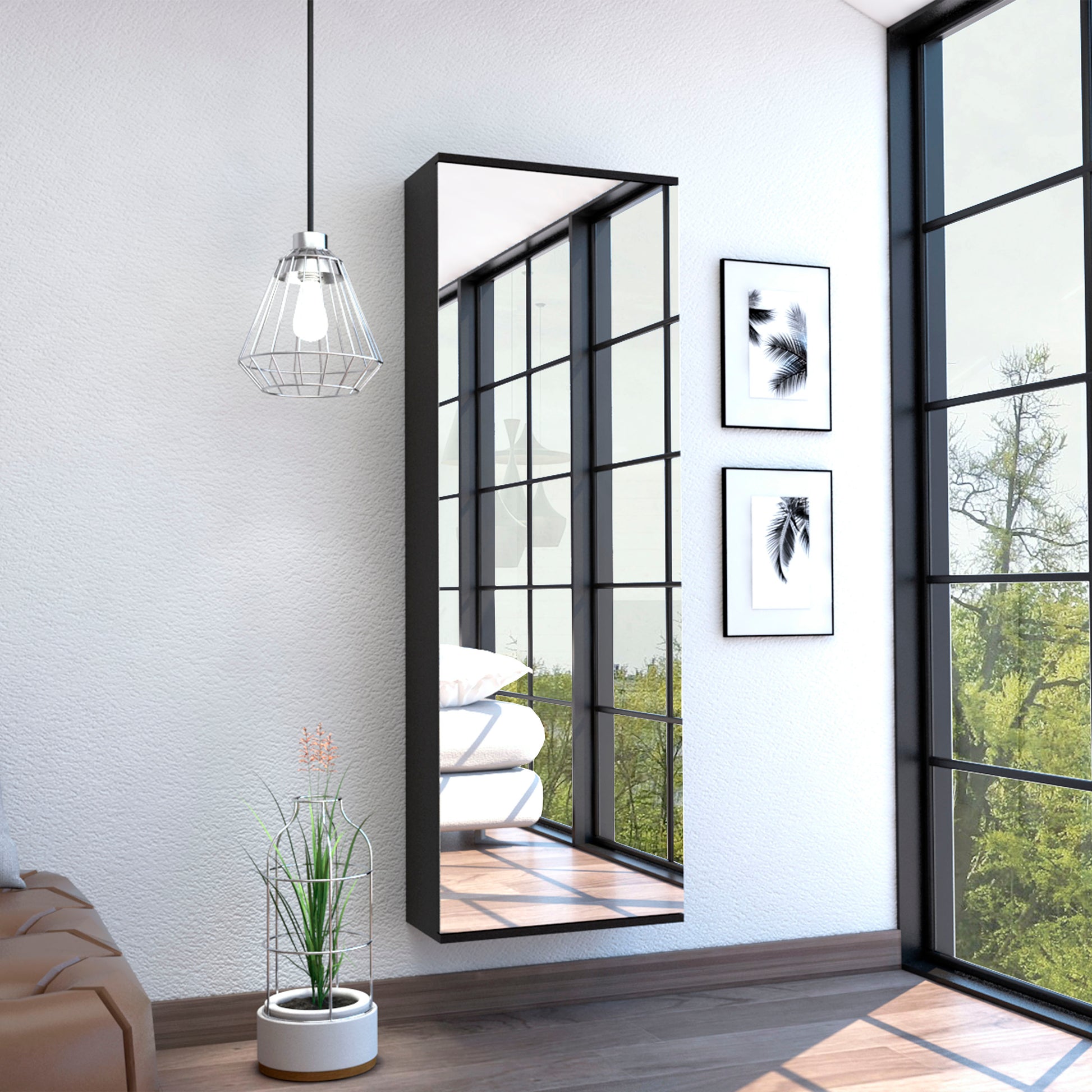 Tall black modern wall mirror reflecting light and greenery