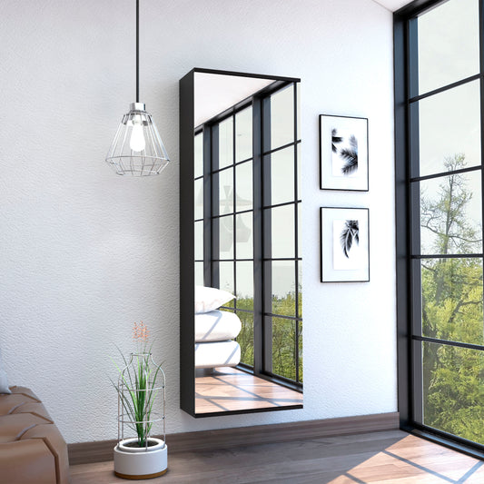 Tall black modern wall mirror reflecting light and greenery