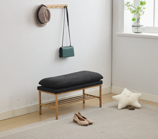Dark grey upholstered entryway bench with slatted shoe rack
