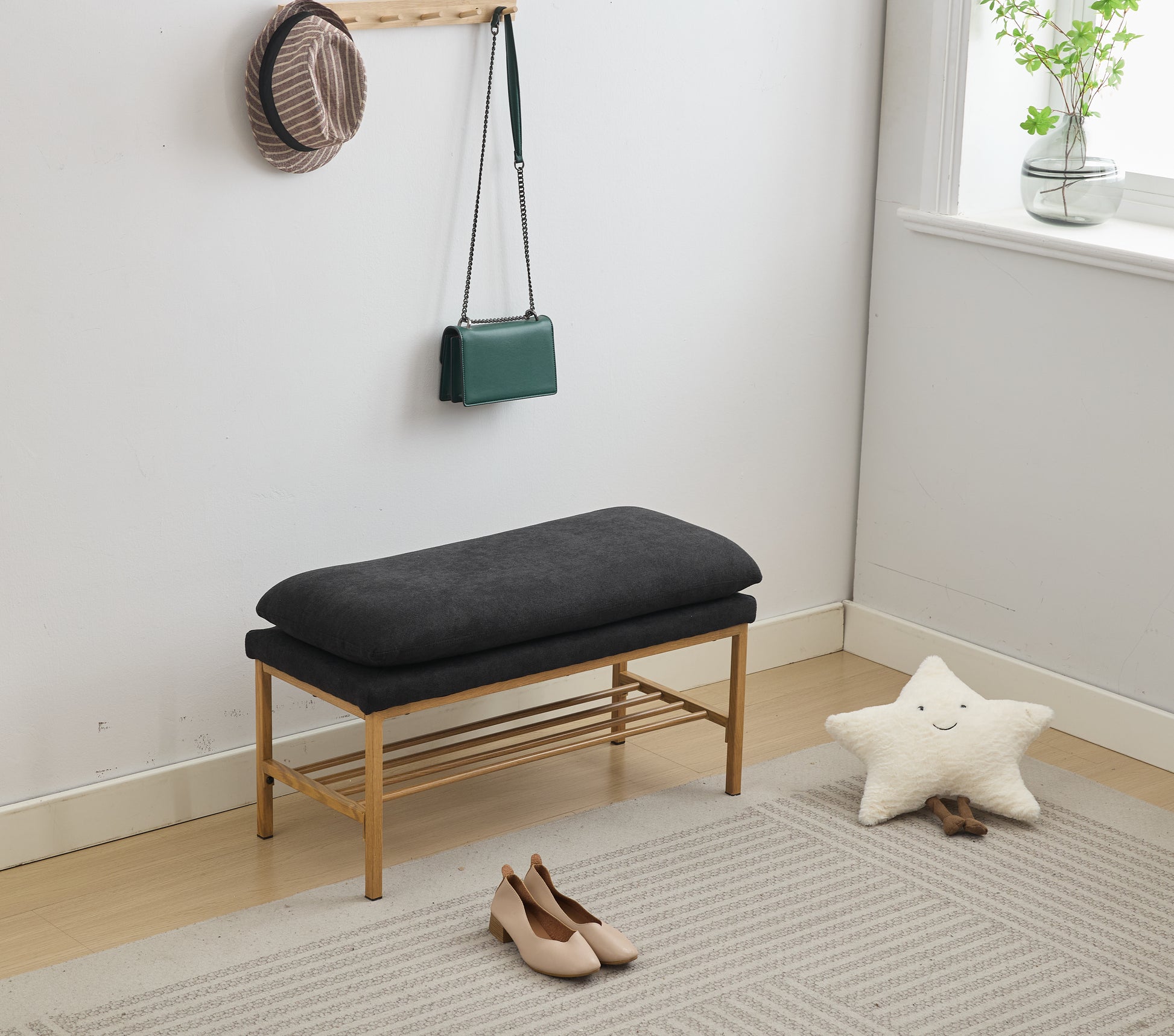 Dark gray upholstered entryway bench with wooden slatted shoe shelf