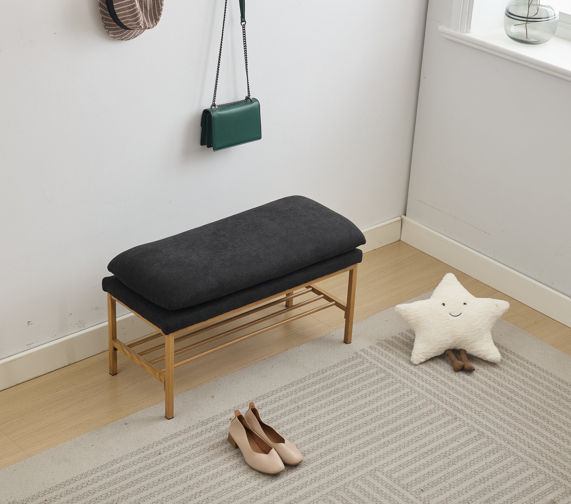 Dark gray upholstered entryway bench with gold metal frame