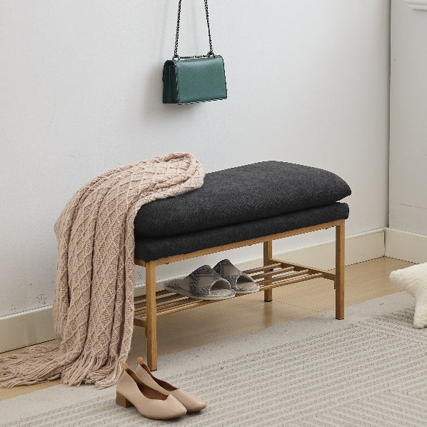 Dark gray upholstered entryway bench with wooden frame and shoe rack