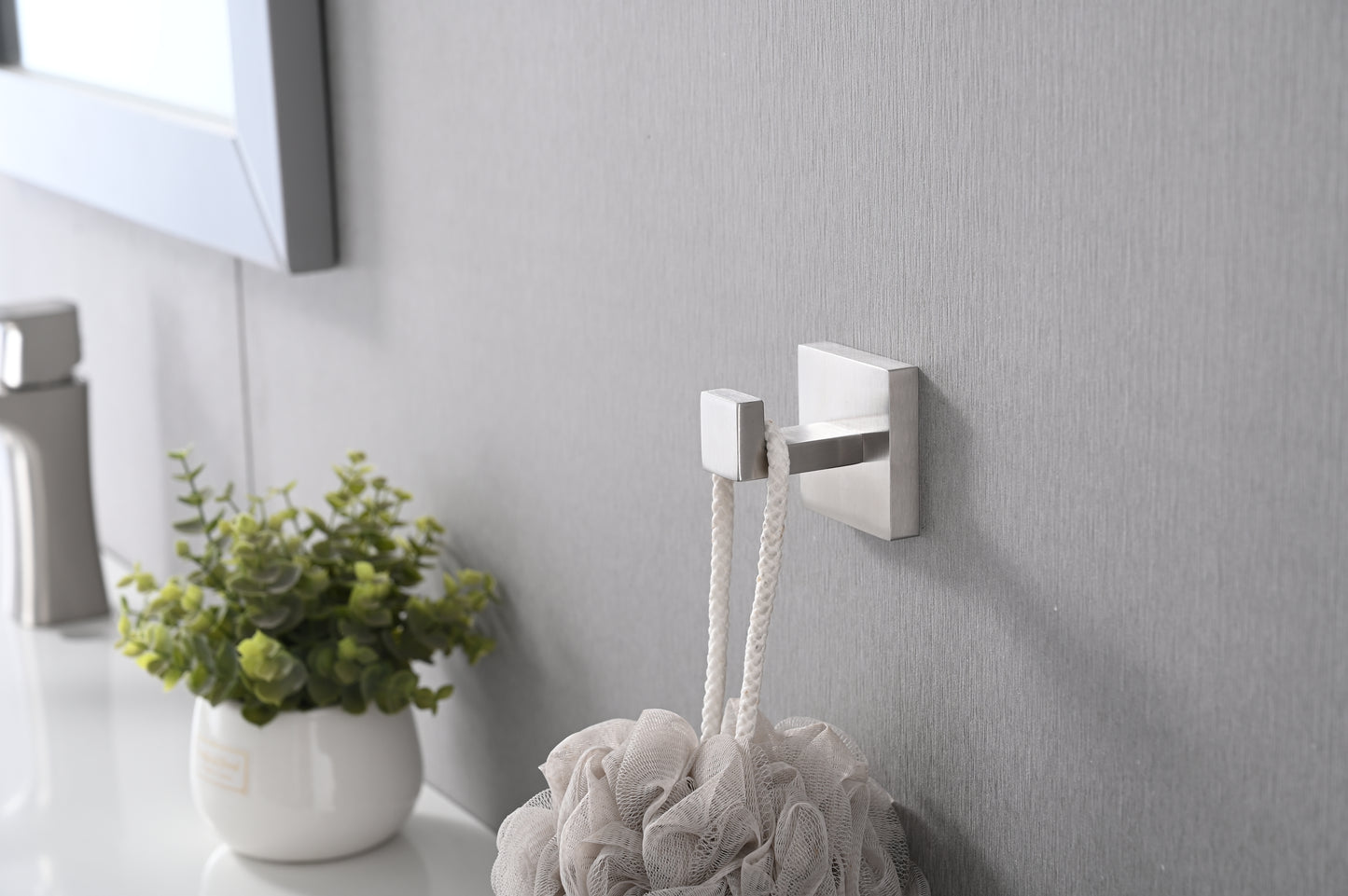 Modern brushed nickel wall hook for hanging bath towels or robes