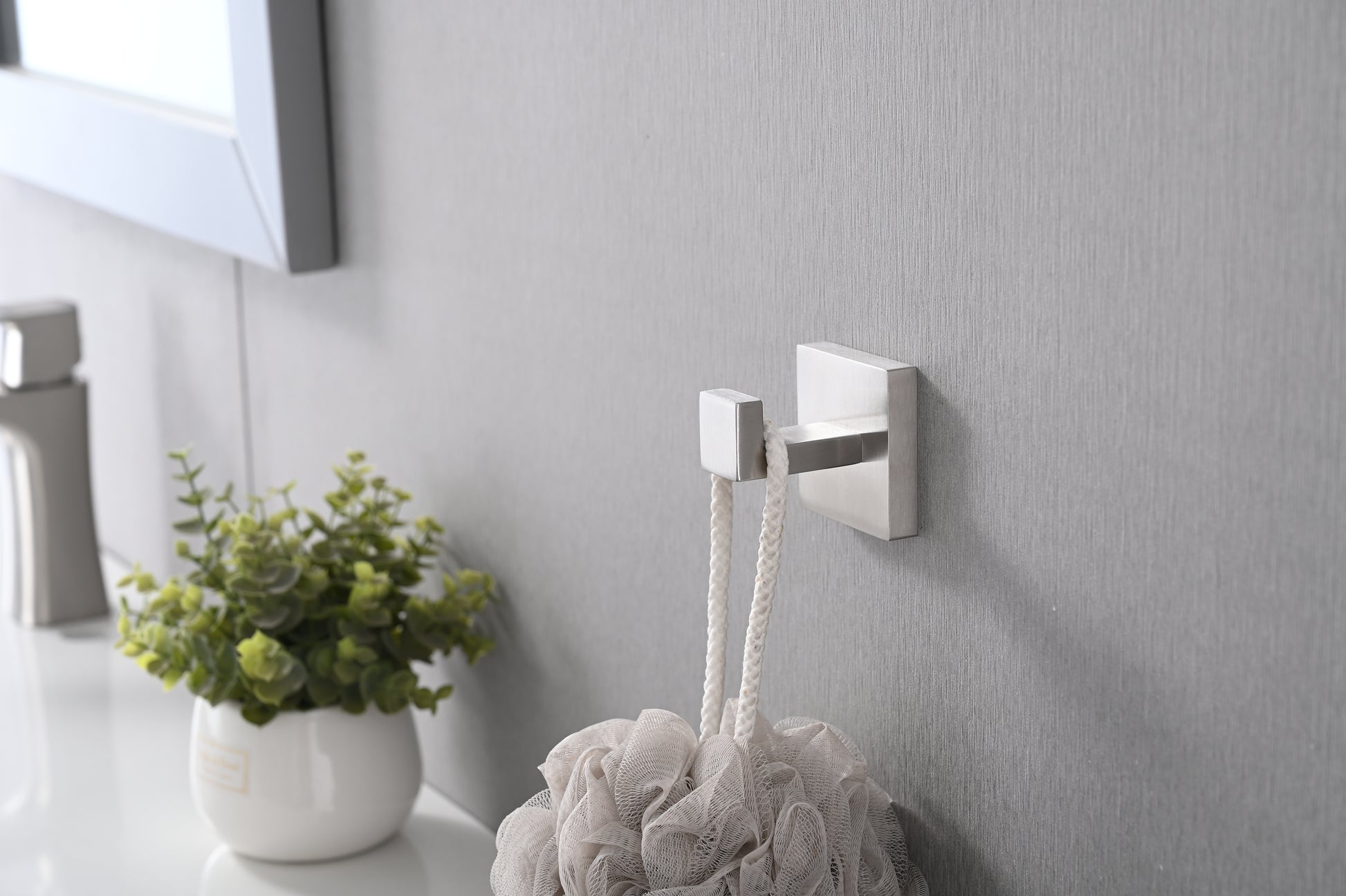 Modern brushed nickel wall hook for hanging bath towels or robes