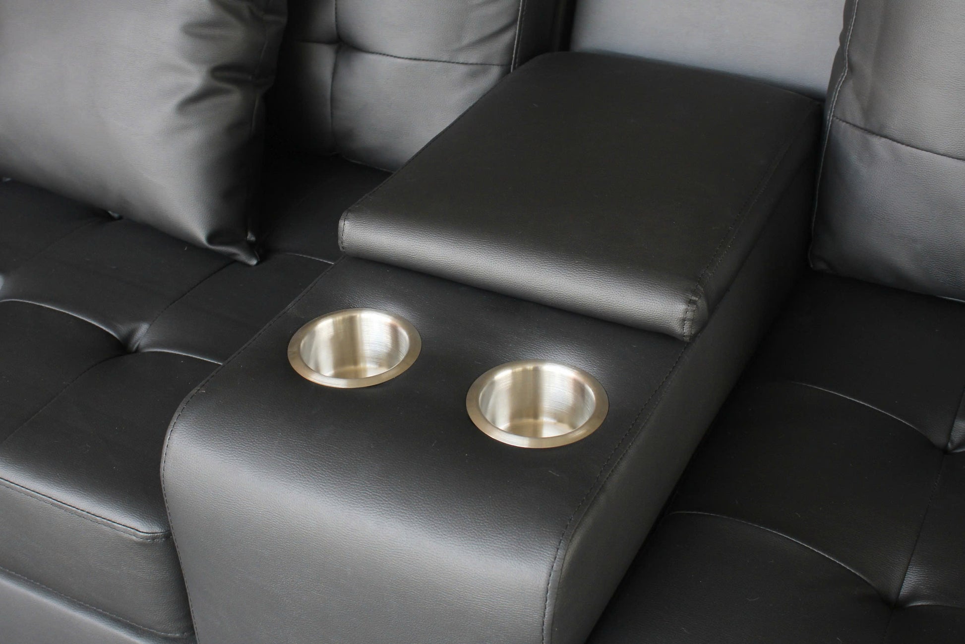 Black faux leather sofa armrest with two stainless steel cup holders for home theater seating