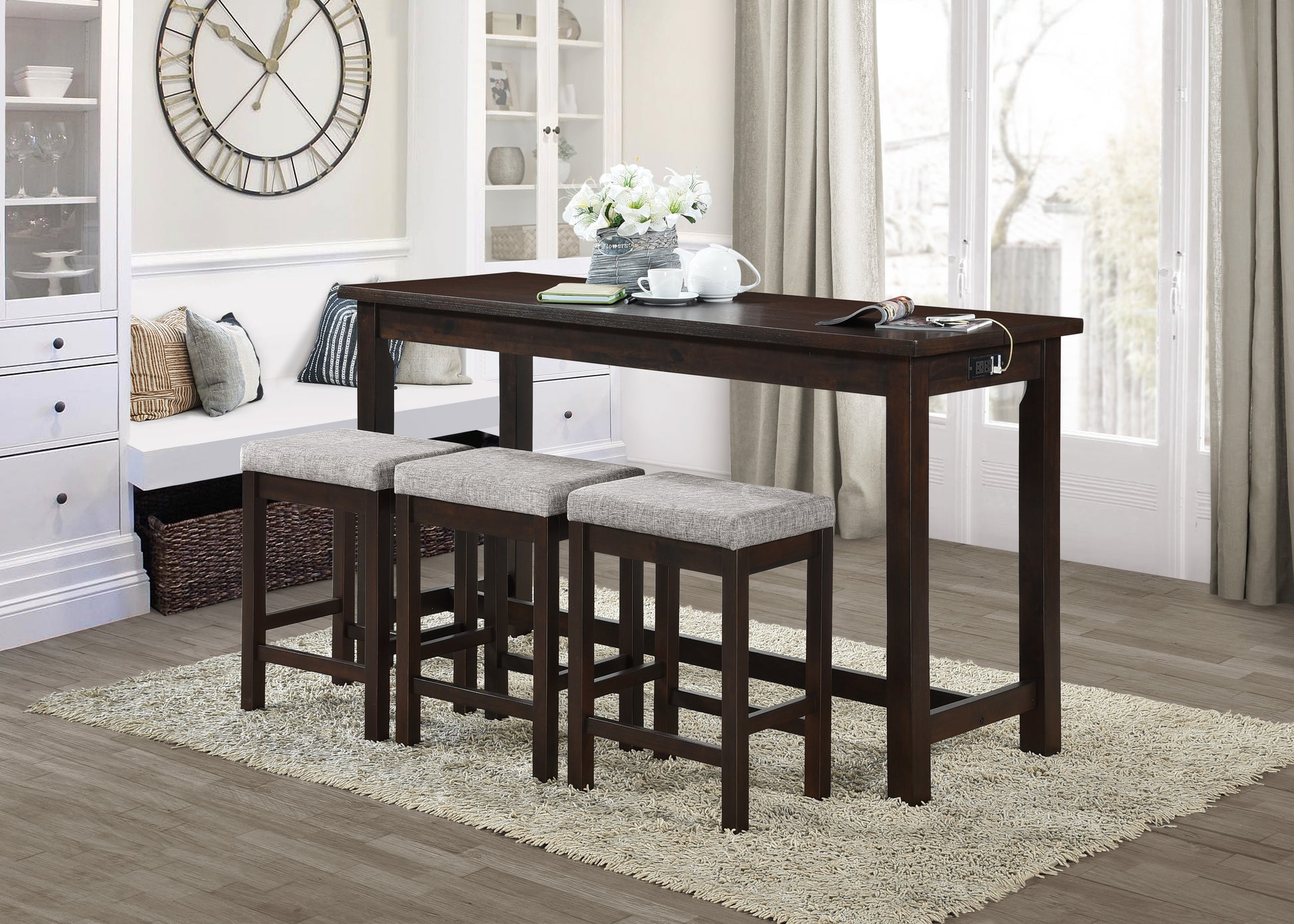 Dark wood counter height dining table with builtin charging station and three grey upholstered stools