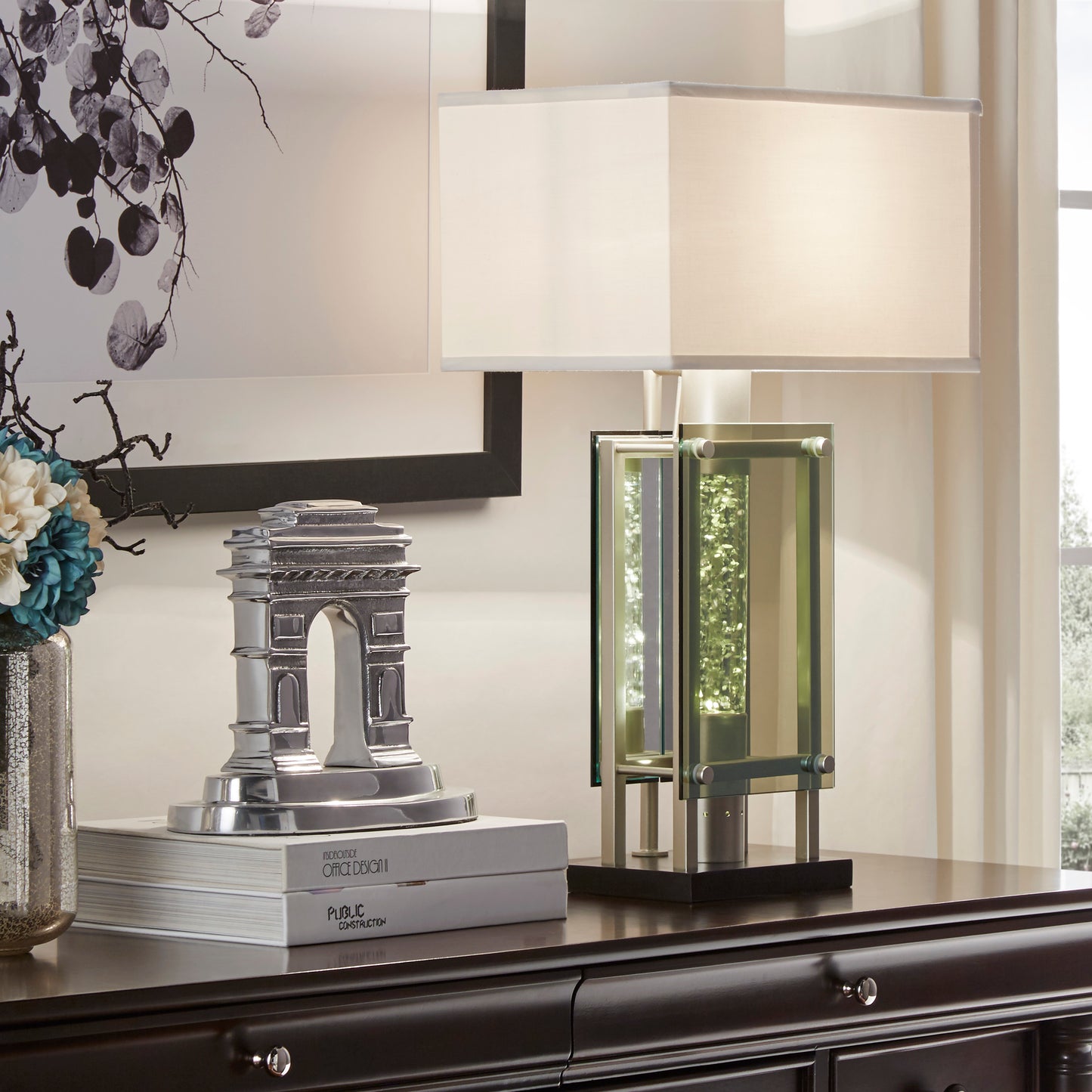 Modern rectangular table lamp with chrome accents and clear crystalfilled glass column