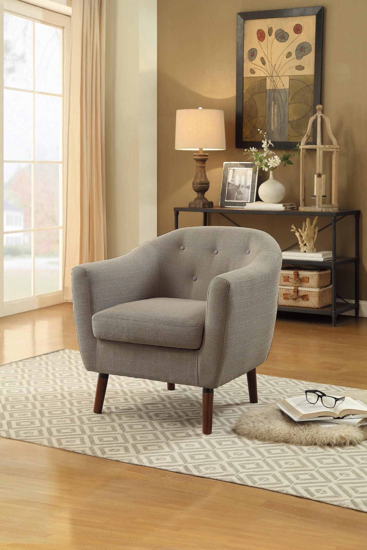 Tufted grey fabric armchair with tapered wooden legs perfect for modern living rooms