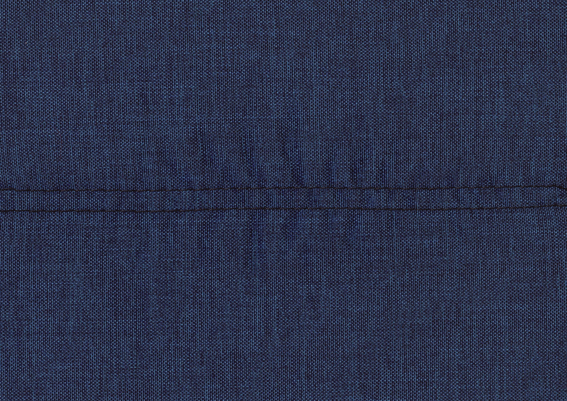Closeup of a dark blue woven fabric texture with a contrasting black stitch detail