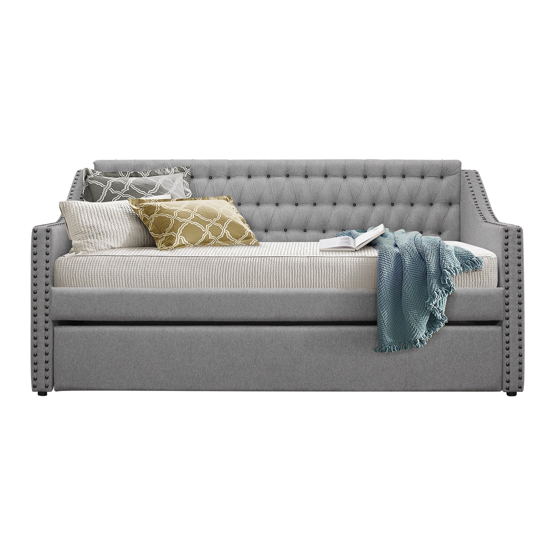 Gray upholstered daybed with tufted back and studded arms featuring decorative pillows and a teal throw
