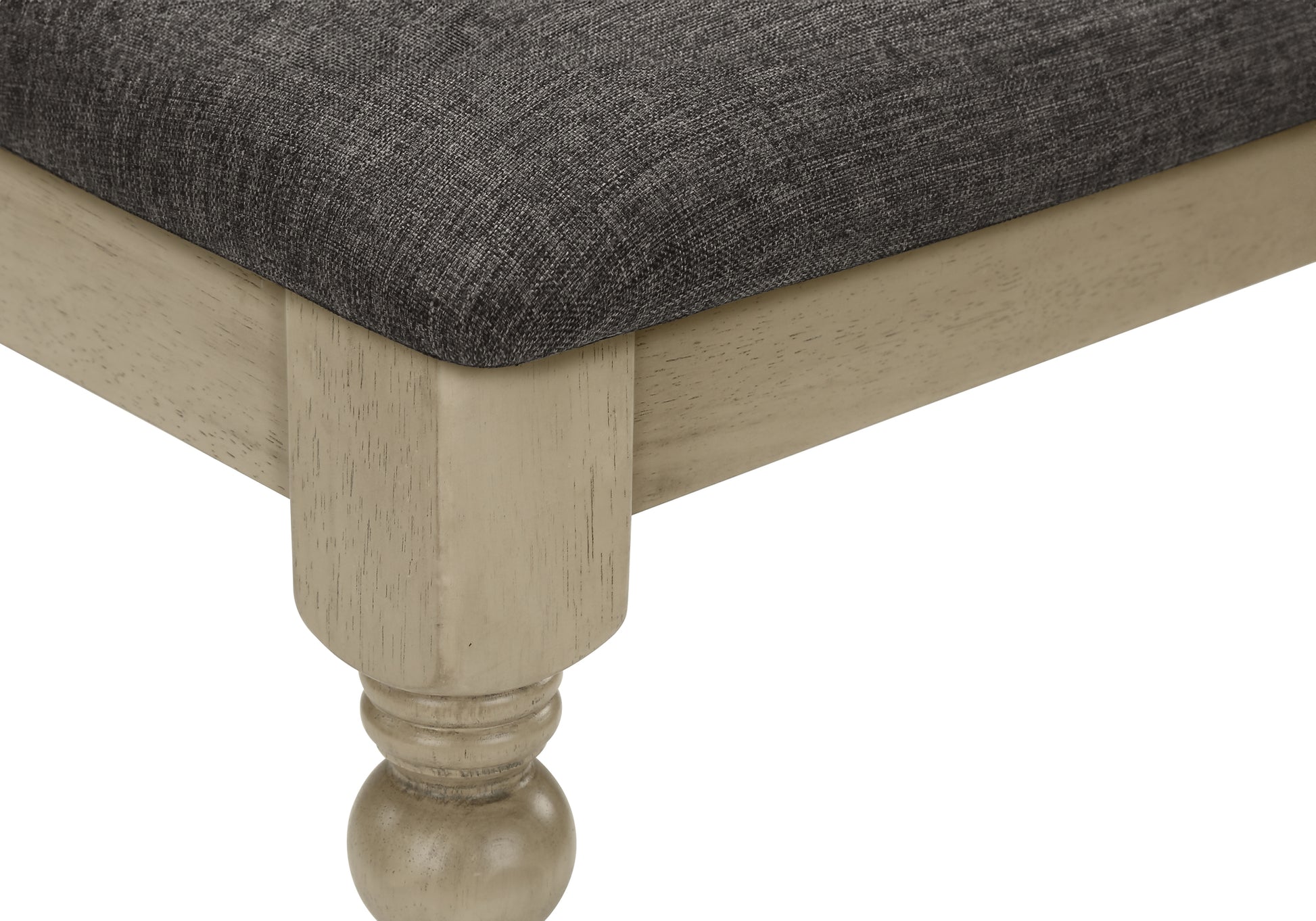 Dark gray upholstered bench seat with a distressed wood frame and turned leg detail