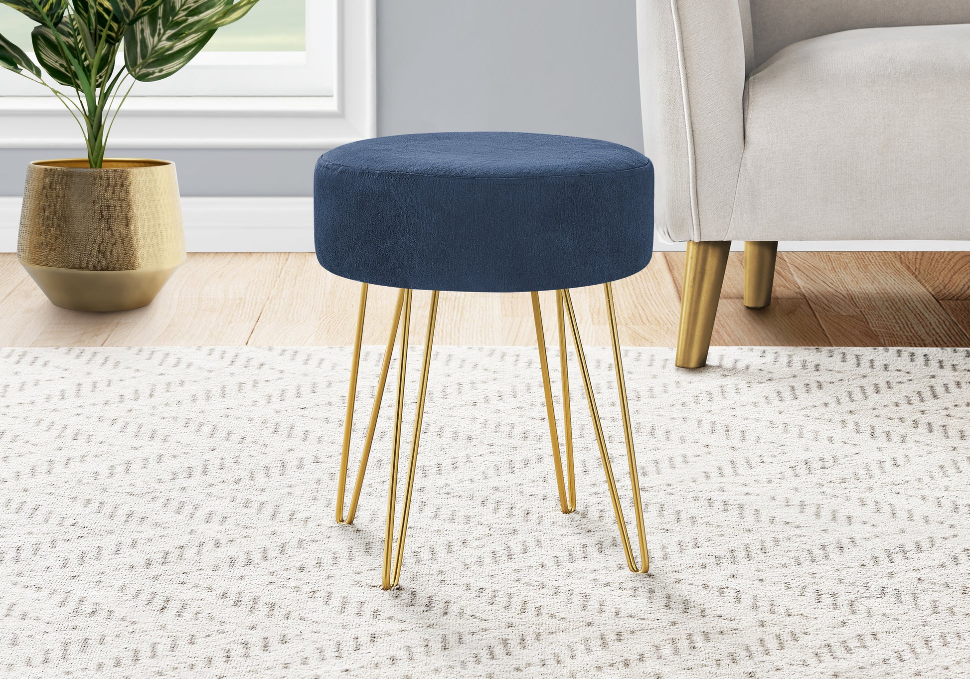 Navy blue fabric ottoman with modern gold hairpin legs